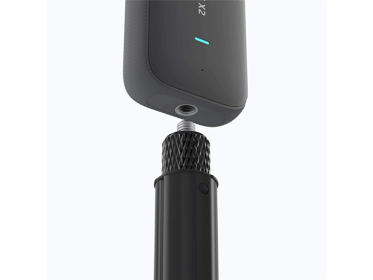 Insta360 selfie stick fully extended for high-angle action photography